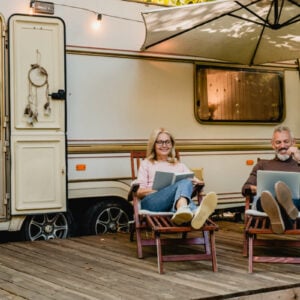 Senior couple enjoying their renovated old caravan